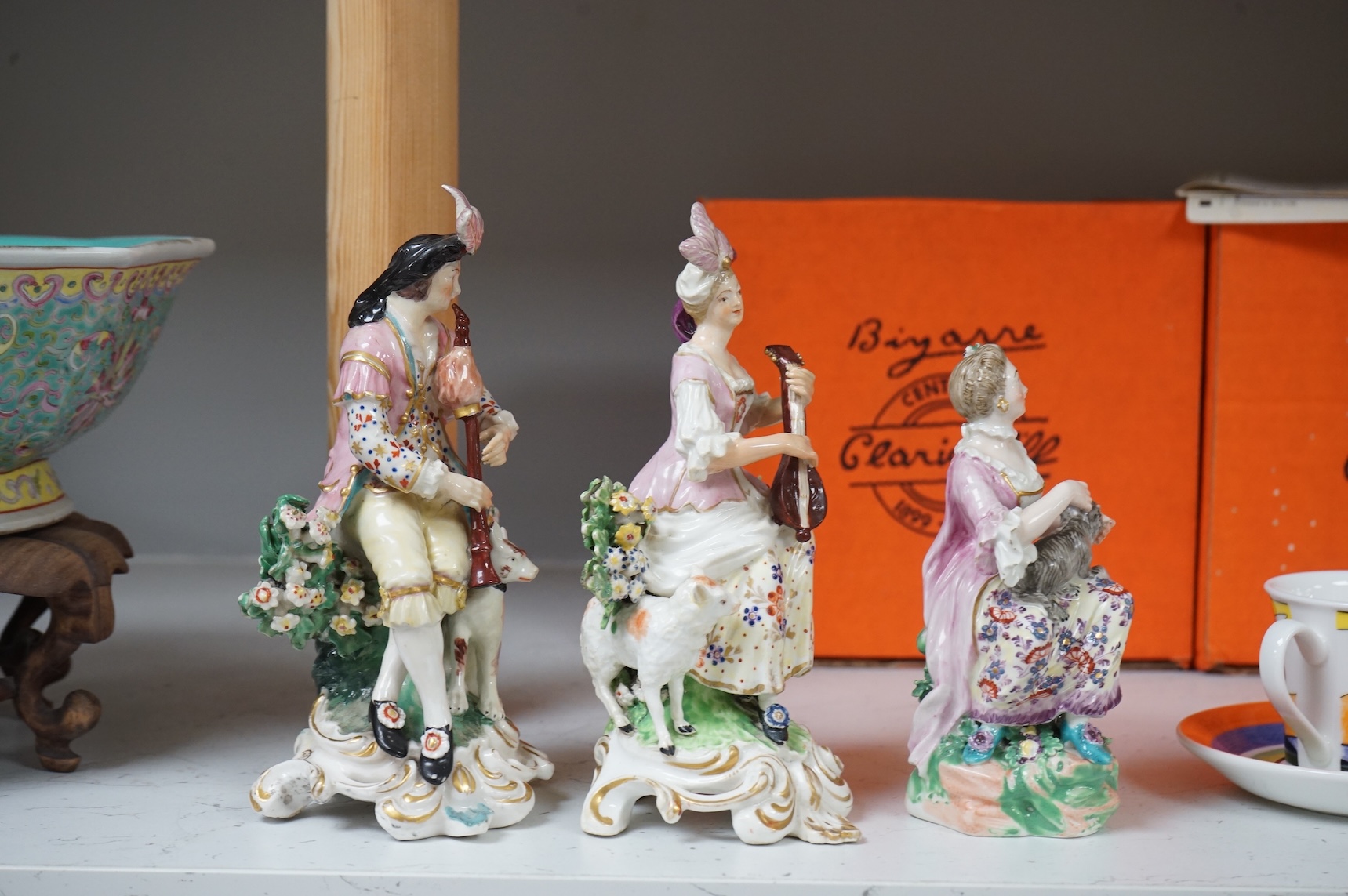 A pair of Derby porcelain figures of musicians, and another of a lady and cat, late 18th century, largest 18cm high